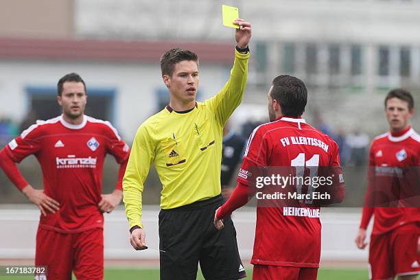 Referee Patrick Hanslbauer shows the yellow card to Tobias Heikenwaelder of Illertissen during the Regionalliga Bayern match between FV Illertissen...