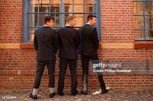 Actors Florian Wuensche, Dominic Saleh-Zaki and Jo Weil pretend to take a leak during the 18th anniversary celebration of the TV-show 'Verbotene...