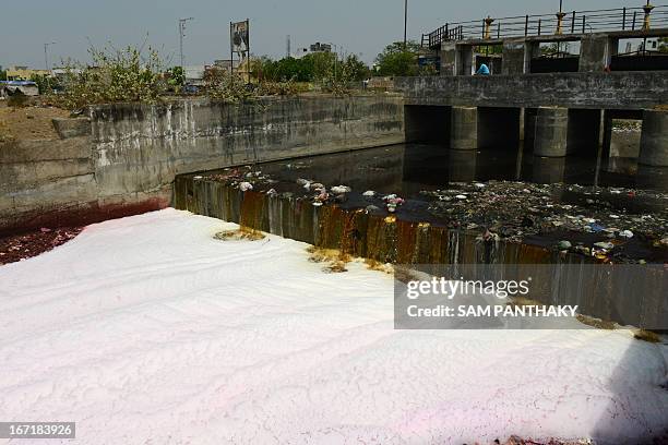 Polluted waters flow down a canal on the outskirts of Ahmedabad during World Earth Day on April 22, 2013. World Earth Day is observed each April 22,...