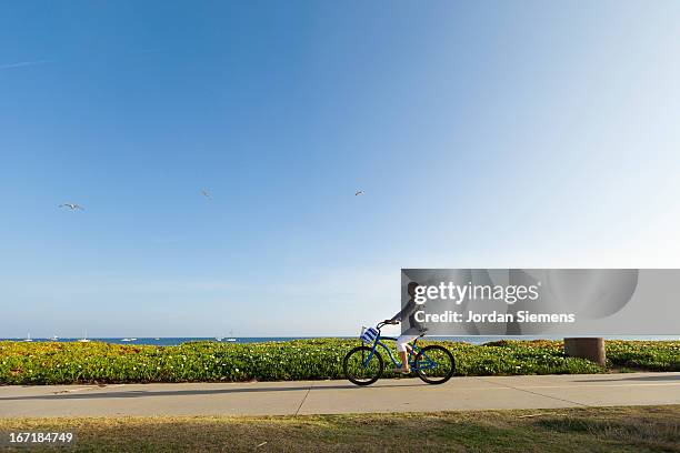 riding a cruiser bike. - woman on bicycle stock pictures, royalty-free photos & images