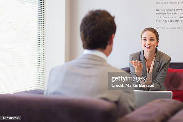 business people talking face to face in lobby - chaise lounge bildbanksfoton och bilder