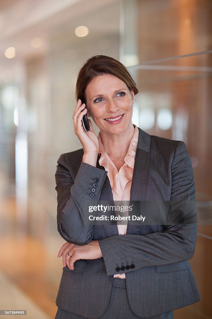 Smiling businesswoman talking on cell phone