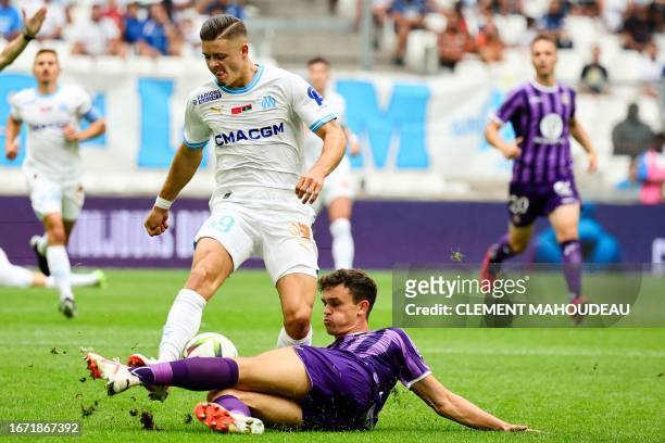 Marseille's Portuguese forward Vitor Manuel Carvalho De Oliveira is tackled by Toulouse's Danish defender Rasmus Nicolaisen during the French L1...