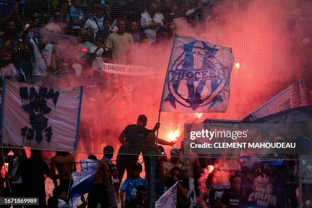 Marseille's supporters cheer their team during the French L1 football match between Olympique Marseille and Toulouse FC at Stade Velodrome in...