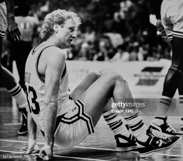 American basketball player Larry Bird, Boston Celtics small forward, sitting on the basketball court during an NBA match, United States, 1984.