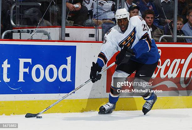 Right wing Mike Grier of the Washington Capitals skates with the puck against the Dallas Stars on October 11, 2002 at the MCI Center in Washington...