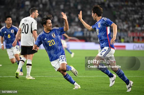 Ao Tanaka of Japan celebrates with teammate Takefusa Kubo after scoring the team's fourth goal during the international friendly match between...