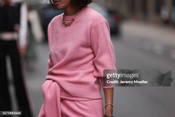 Aimee Song is seen outside Tibi show wearing black Bottega Veneta sunnies, golden Tiffany hardware necklace and pink colored cotton set on September...