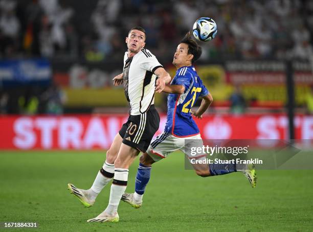 Robin Gosens of Germany is challenged by Takefusa Kubo of Japan during the international friendly match between Germany and Japan at Volkswagen Arena...