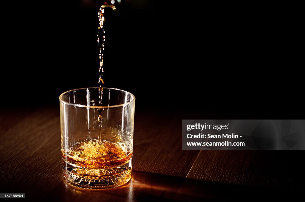 Whiskey being poured into a glass