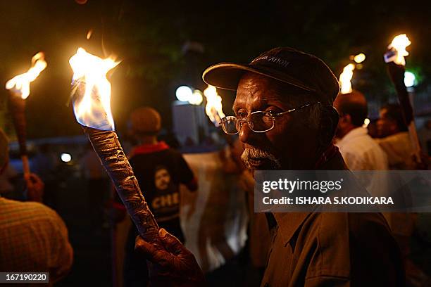 Activists from the Sri Lankan People's Liberation Front , the country's main Marxist party, carry lit torches as they protest against electricty...