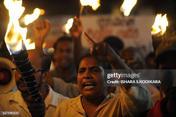 Activists from the Sri Lankan People's Liberation Front , the country's main Marxist party, carry lit torches as they protest against electricty...