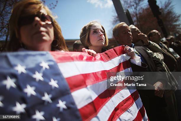 Jaime Caputo holds an American flag outside the funeral for 29-year-old Krystle Campbell, who was one of three people killed in the Boston Marathon...