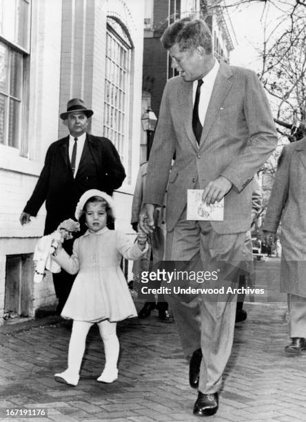 President-elect Kennedy walks with his daughter Caroline on their way to church services on her third birthday, Washington DC, November 27, 1960....