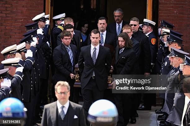 Firefighters salute as pallbearers carry the casket of Krystle Campbell, a victim of the Boston Marathon bombing, from St. Joseph Catholic Church...