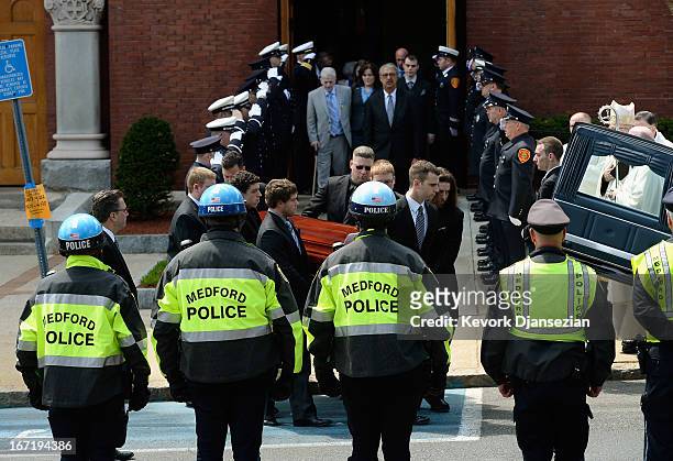 Firefighters salute as pallbearers carry the casket of Krystle Campbell, a victim of the Boston Marathon bombing, from St. Joseph Catholic Church...