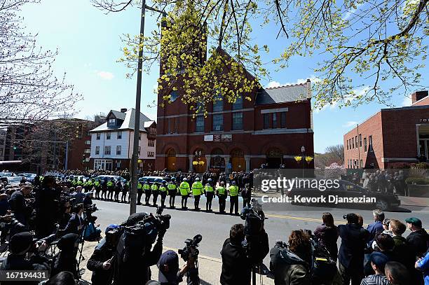 The media stand across the street as Medford Police line the street while the hearse arrives at St. Joseph Catholic Church for the funeral of Krystle...