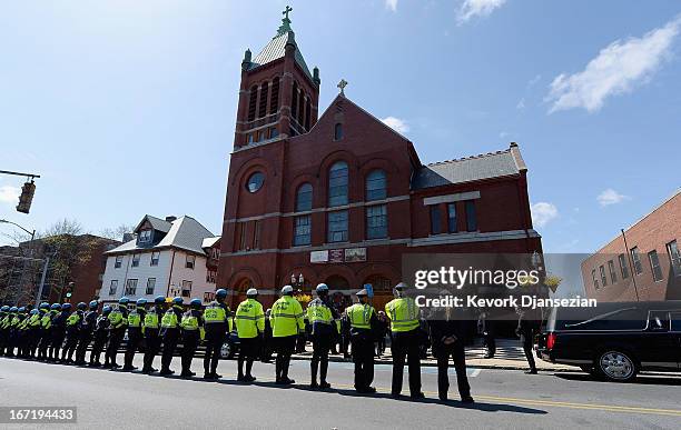 Medford Police line the street as the hearse arrives at St. Joseph Catholic Church for the funeral of Krystle Campbell, a victim of the Boston...