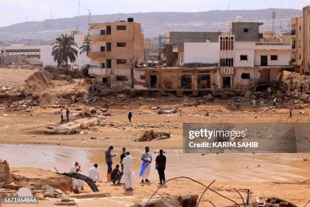 Rescue teams assist in relief work in Libya's eastern city of Derna September 17, 2023 following deadly flash floods. A week after a tsunami-sized...