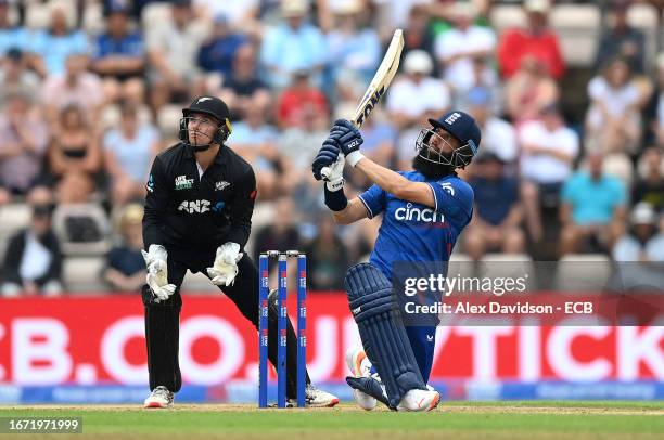 Moeen Ali of England hits a six watched on by Tom Latham of New Zealand during the 2nd Metro Bank ODI between England and New Zealand at The Ageas...