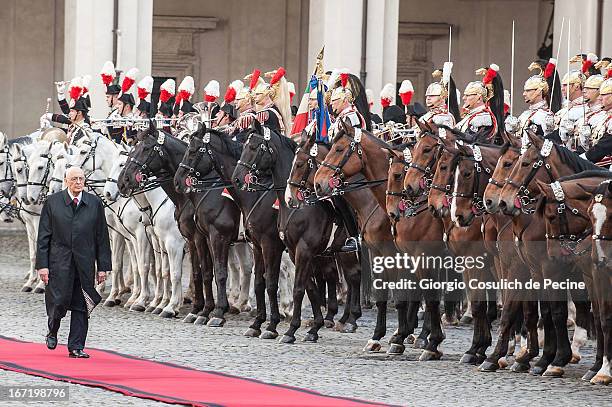 Newly elected President Giorgio Napolitano walks in front of the guard of honor as he arrives at Palazzo del Quirinale on April 22, 2013 in Rome,...