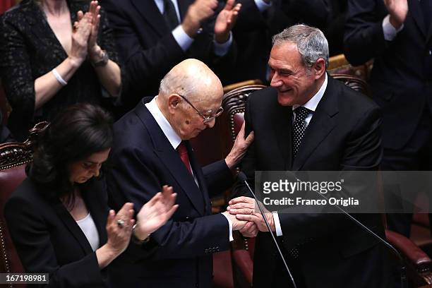 Newly reelected Italian President Giorgio Napolitano shakes hands with President of Senate Pietro Grasso as President of the Chamber of Deputies...