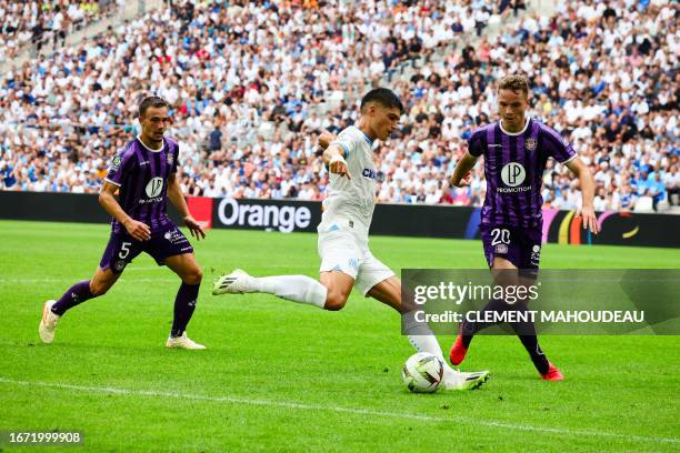 Marseille's Argentinian forward Joaquin Correa fights for the ball with Toulouse's German midfielder Niklas Schmidt and Toulouse's Australian...