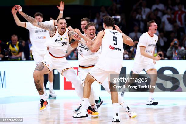 Daniel Theis, Moritz Wagner and Franz Wagner of Germany celebrate after the FIBA Basketball World Cup Final victory over Serbia at Mall of Asia Arena...