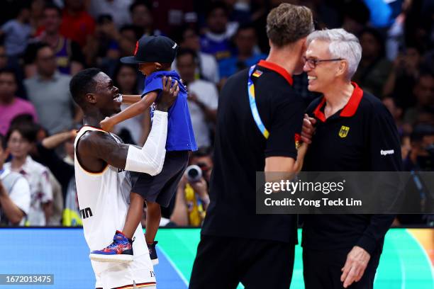 Dennis Schroder of Germany celebrates with his son after the FIBA Basketball World Cup Final victory over Serbia at Mall of Asia Arena on September...