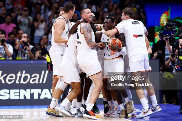 Dennis Schroder of Germany celebrates with teammates after the FIBA Basketball World Cup Final victory over Serbia at Mall of Asia Arena on September...
