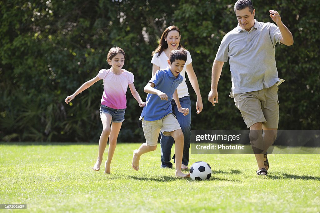 Children Playing Soccer With Parents