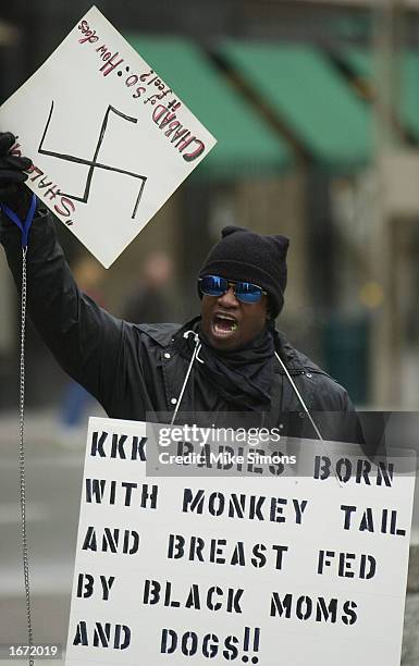 Protester from the group known as Blackfist shouts at passerbys in front of a menorah on Fountain Square December 4, 2002 in downtown Cincinnati,...