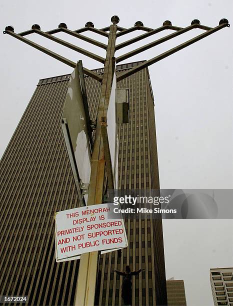 Sign hangs on a Menorah declaring that the symbol was placed by private groups on Fountain Square December 4, 2002 in downtown Cincinnati, Ohio....