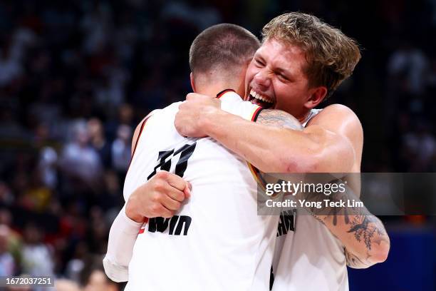 Daniel Theis and Moritz Wagner of Germany celebrate after the FIBA Basketball World Cup Final victory over Serbia at Mall of Asia Arena on September...