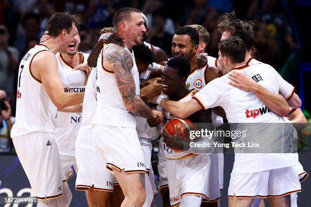 Dennis Schroder of Germany celebrates with teammates after the FIBA Basketball World Cup Final victory over Serbia at Mall of Asia Arena on September...