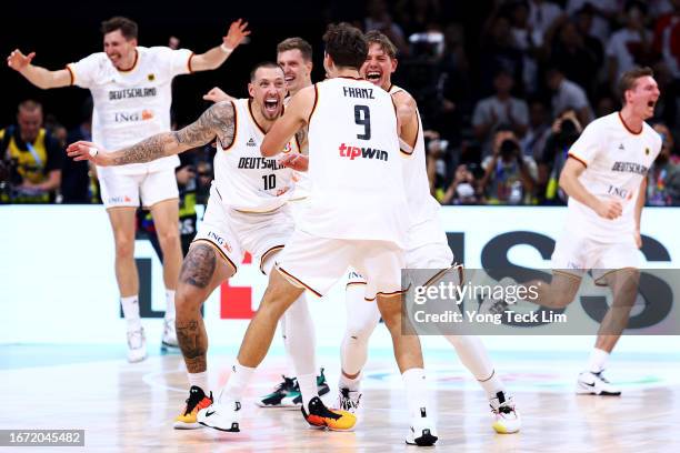 Daniel Theis, Franz Wagner and Moritz Wagner of Germany celebrate after the FIBA Basketball World Cup Final victory over Serbia at Mall of Asia Arena...