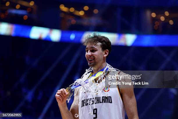 Franz Wagner of Germany poses with his gold medal and the net after the FIBA Basketball World Cup Final victory over Serbia at Mall of Asia Arena on...