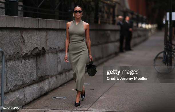 Tamara Kalinic is seen outside Khaite show wearing black Balenciaga. Sunnnies, silver Bottega Veneta earrings, dark green Khaite slim dress, black...