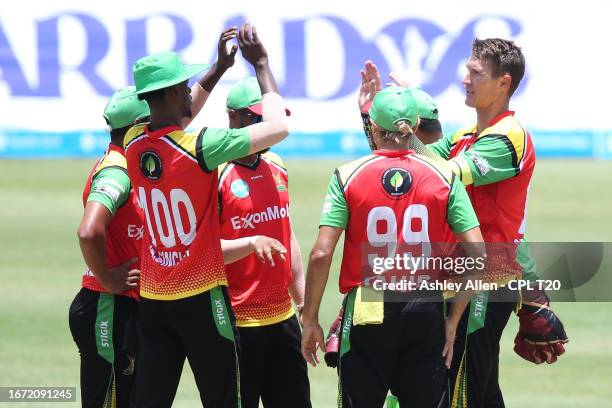 Dwaine Pretorius of Guyana Amazon Warriors celebrates with teammates after getting the wicket of Rahkeem Cornwall of Barbados Royals during the...