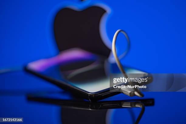 Smartphone with USB -C cable with Apple seen in the background.on september 17 in Brussels, Belgium.