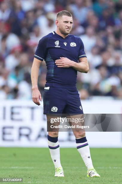Finn Russell of Scotland clutches his ribs having appeared to have suffered an injury during the Rugby World Cup France 2023 match between South...