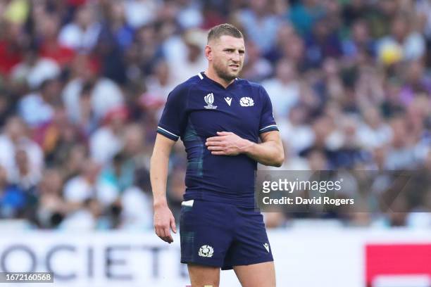 Finn Russell of Scotland clutches his ribs having appeared to have suffered an injury during the Rugby World Cup France 2023 match between South...