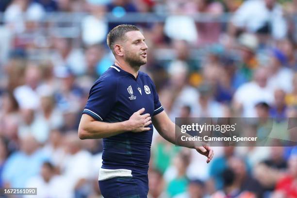 Finn Russell of Scotland touches his ribs having appeared to have suffered an injury during the Rugby World Cup France 2023 match between South...