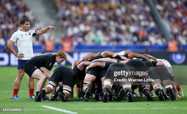 Finlay Christie of New Zealand feeds the scrum as his opposite number Antoine Dupont of France gestures during the Rugby World Cup France 2023 match...