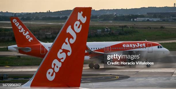 EasyJet aircraft cross each other while one of them taxies for take off at Orly International Airport on September 10, 2023 in Paris, France. EasyJet...