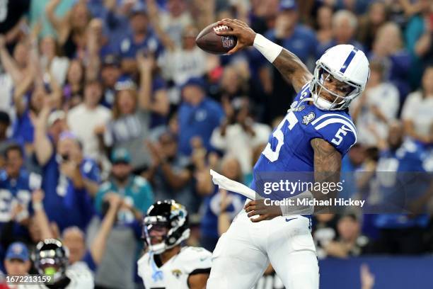 Anthony Richardson of the Indianapolis Colts spikes the football after running for a touchdown in the second quarter of a game against the...