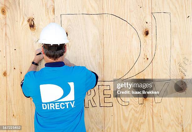 DirecTV CEO Mike White signs a wall as DirectTV volunteers build homes for Southern Nevada families with Habitat for Humanity on April 22, 2013 in...