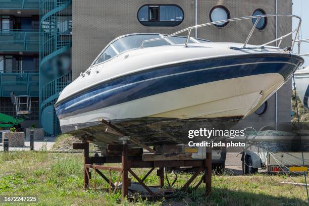 speedboat stands outside on a steel structure - grey pier stock pictures, royalty-free photos & images