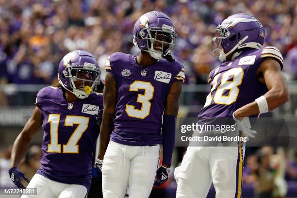 Jordan Addison celebrates with Justin Jefferson and K.J. Osborn of the Minnesota Vikings after scoring a touchdown in the second quarter of a game...