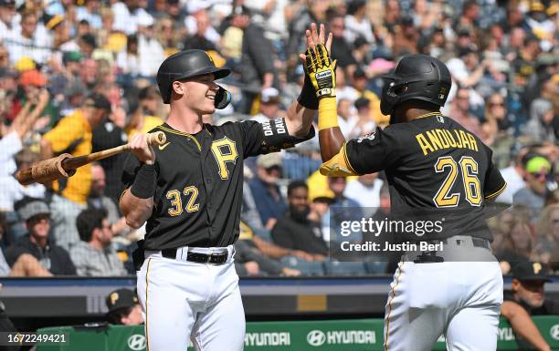 Miguel Andujar of the Pittsburgh Pirates celebrates with Henry Davis after hitting a solo home run in the fourth inning during the game against the...